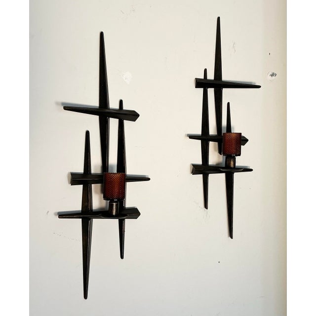 Pair of vintage midcentury brutalist metal wall candle sconce, from the 60s. Holds it's original diamond point amber-...