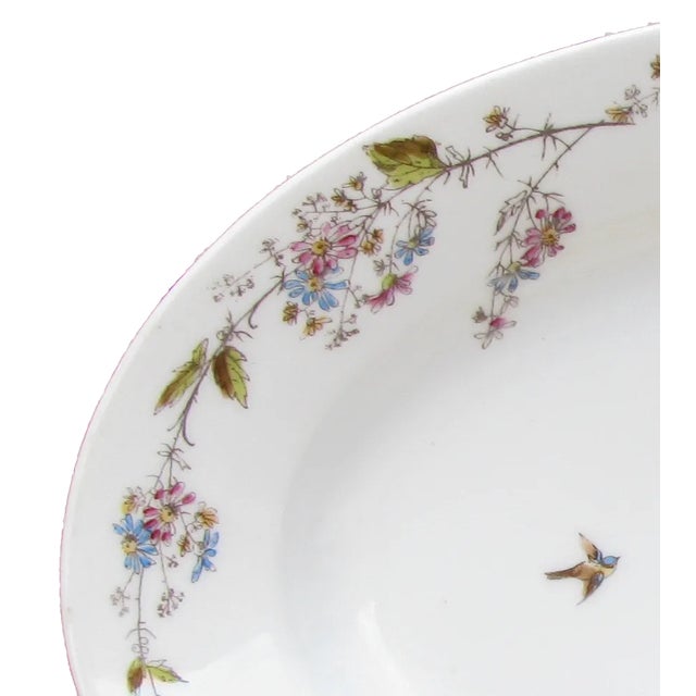 This lovely French Limoges platter features a floral garland encircling the rim and delicate birds soaring across the...