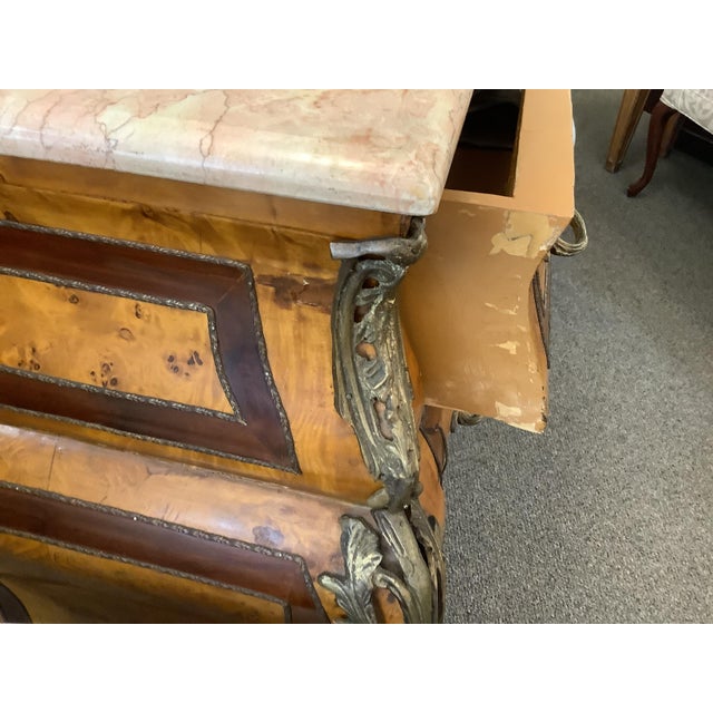 French style walnut bombe chest with marble top and ormolu pulls and escutcheons. Walnut banding around the drawers.