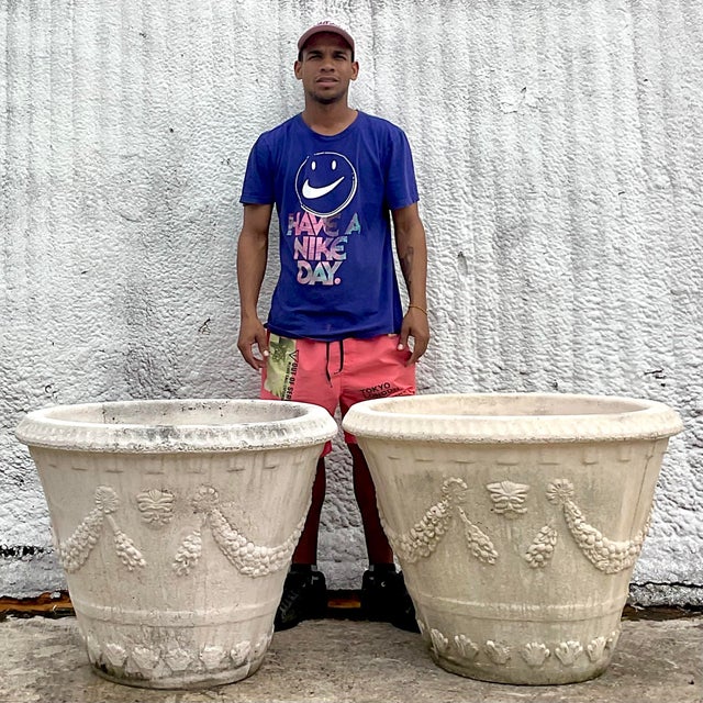 A striking pair of vintage Coastal planters. A chic swag garland design in a pale oyster finish. Monumental in size and...