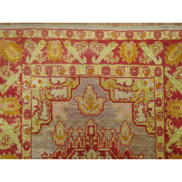 An authentic early 20th century Turkish Oushak featuring a lime green color on a silver colored ground. 3'10'' x 6'1''