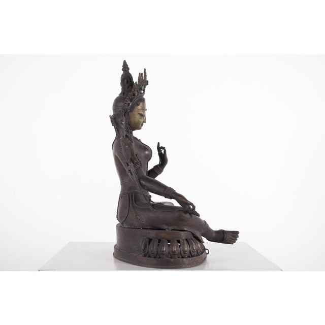 Figure of a Nepalese female goddess in green copper alloy, 19th century. H 41 cm x W 28 cm x D 20 cm, 5490 grams....