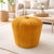 A compact Scandinavian pouf from the 1970s, featuring a cylindrical form and upholstered in mustard-colored corduroy...