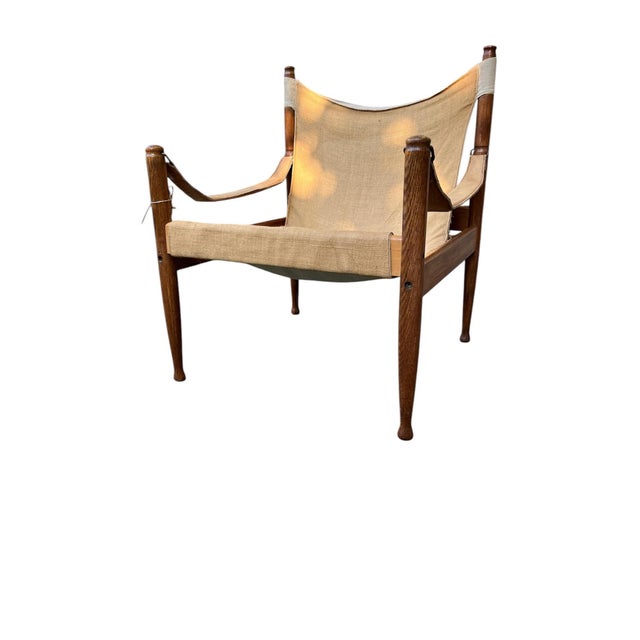 Mid Century Safari Chair of the Danish manufacturer Niels Eilersen after a draft by Erik Wørts. This version impresses...