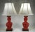 A lovely and rare pair of late 19th Century red cinnabar lacquer lamped vases with shades. The vases feature expertly...