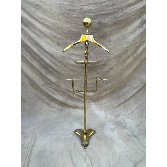 A wonderful brass valet with a unique and heavy base. We have never seen one with a more solid base with lion feet - very...