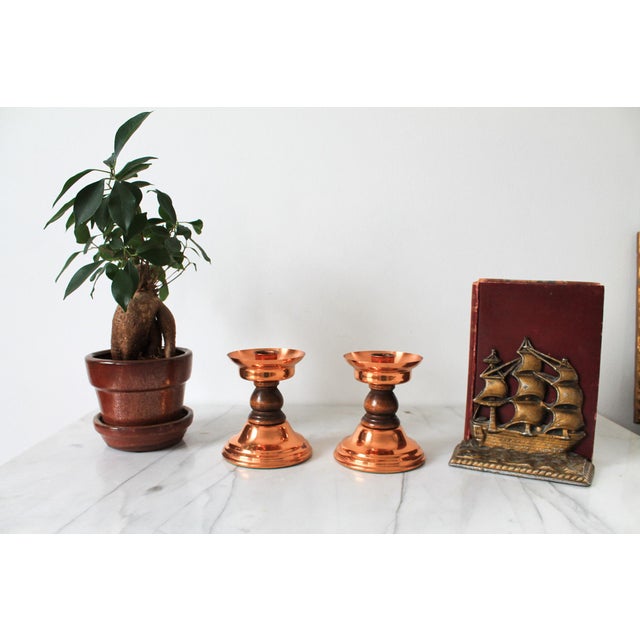 Pair of vintage copper and wood candle holders by "Coppercraft Guild". Made in the USA. Some age wear to copper and...