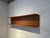 A modernist wall shelf in teak wood manufactured by Pedersen & Hansen in Denmark around 1960. It is easy to hang using...