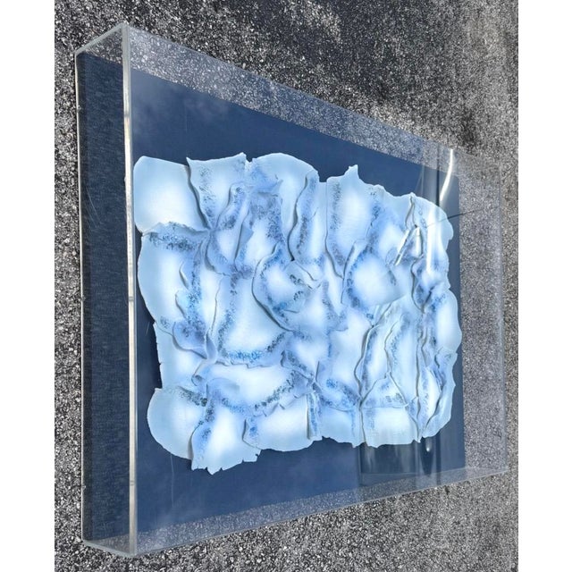 Large sculptural ceramic composition of individually and delicately made "leaves" that are painted with a blue hombre...