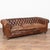 Set of three vintage brown leather Chesterfield seating group consisting of one three seat sofa and one pair of club...