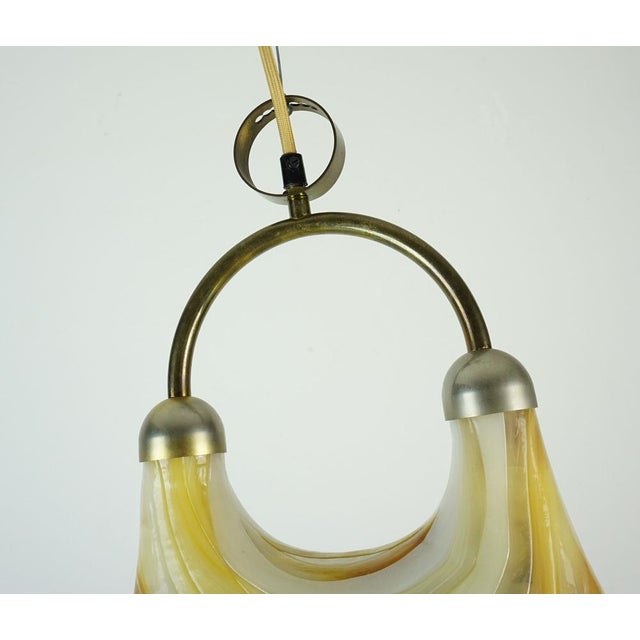Impressive 1970s pendant lamp made of acrylic in white and various shades of beige, ochre, and brown. Metal suspension....