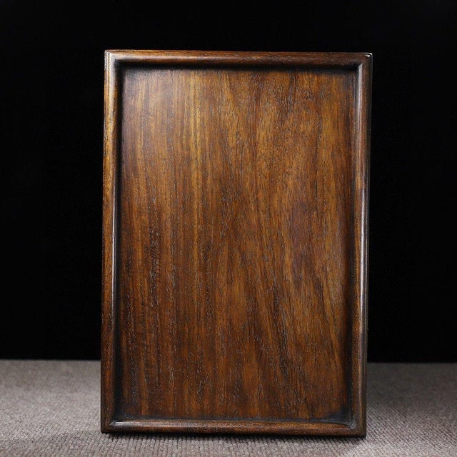 This handcrafted rectangular tray is made from genuine huanghuali wood (Dalbergia odorifera), one of the most prized and...