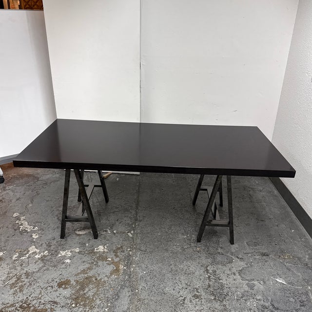 Design Plus Gallery presents a Contemporary Saw Horse Bases Table. The rectangular wood veneer top has a smooth surface...