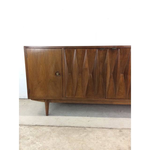 This mid century modern credenza by Albert Parvin for American of Martinsville features hardwood construction, walnut...