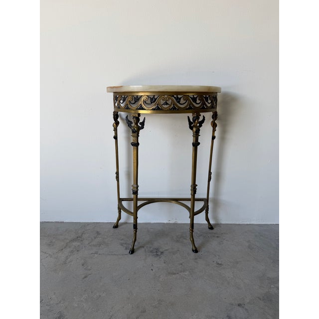 An elegant and highly decorative 1920s Oscar Bach-style console table with matching mirror, showcasing exceptional...