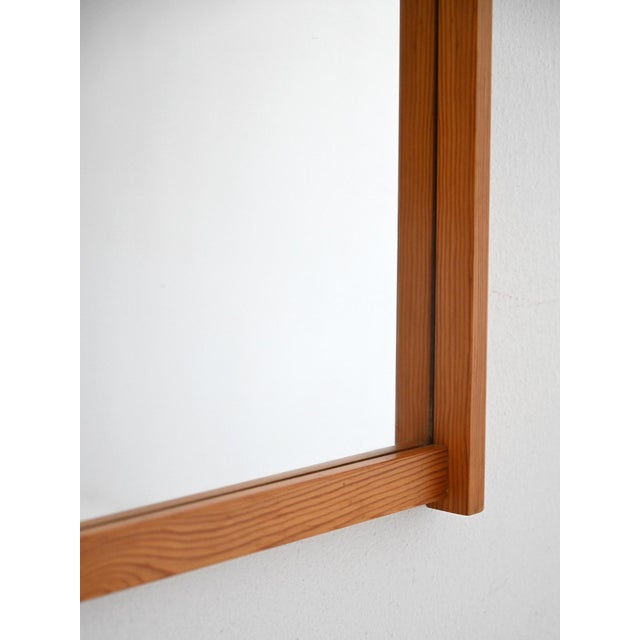 Rectangular mirror with a light pine frame and original label. Simple and understated design typical of Nordic modernism....