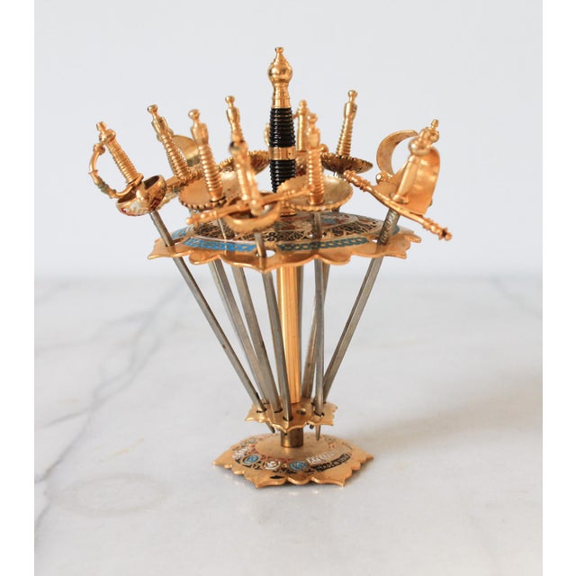 1960's Spanish Toledo brass sword cocktail skewers. Made in Spain. The set includes 11 swords and one stand. Some light...