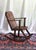 A wonderful rocking chair with handcarved details. Rustic wood planks and carved runners. A combination of plank and...