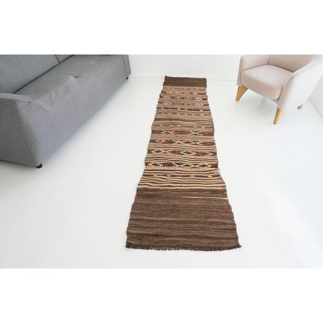 This is a vintage Turkish Oushak rug from the Mid 20th Century. The piece was hand-knotted.