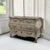 A 19th century Louis XV style bombe commode crafted from solid oak, revealed in a soft stripped finish that glows with the...