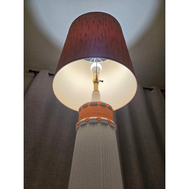 A sensational 1960s Mid-Century Modern atomic ceramic table lamp. This striking sculptural piece features a heavily...