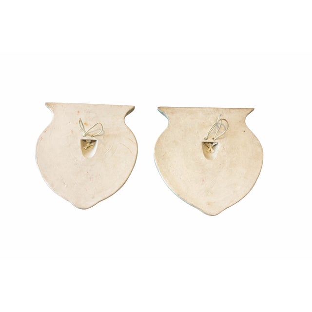 A beautiful pair of mid-century hand-painted porcelain wall pockets in the chinoiserie style, featuring a softly domed...