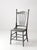 An antique spindle-back chair dating to circa 1890s–1910s, with a tall, graceful silhouette, slender turned spindles, ball...