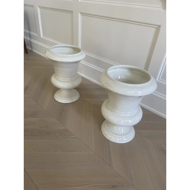 Elevate your space with this stunning pair of large ceramic urns from the Thomas pheasant Collection for Baker Furniture,...