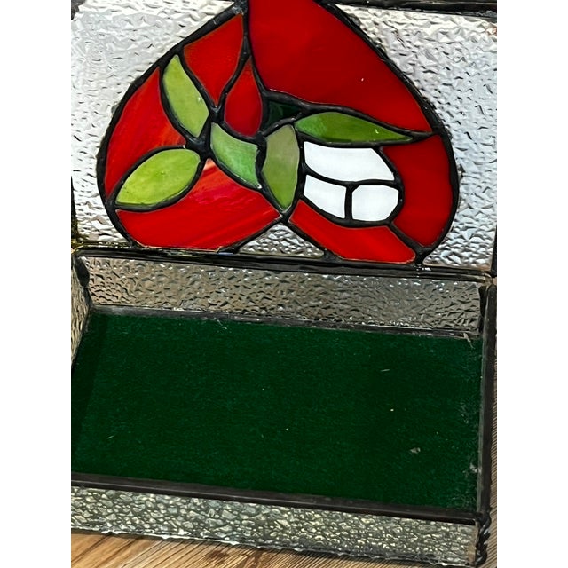 Vintage leaded, footed, stained glass trinket box with green velvet lining.