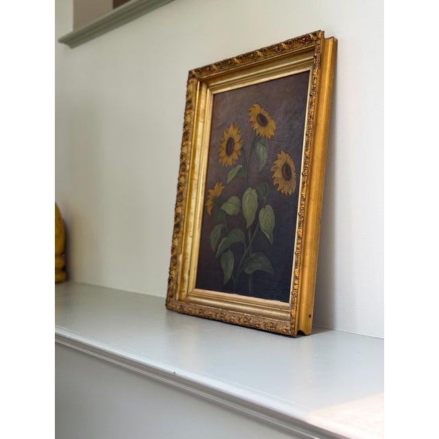 Beautiful dark atmospheric painting of four sunflowers. The back of the board on which the flowers are painted reads, "F....