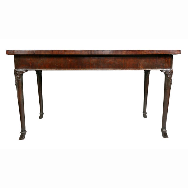 With a rectangular top and plain frieze, the legs with shell carved knee and bellflower within a shaped lambs tongue...