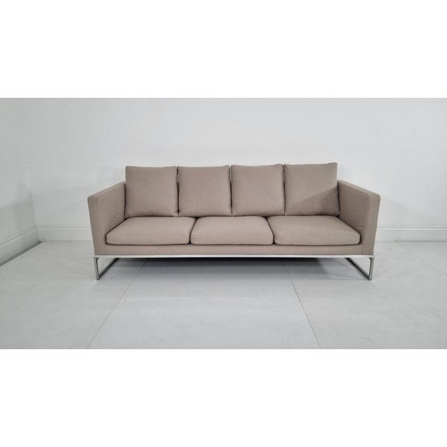 The Tight sofa is characterised by its distinctive tubular steel structure and open steel profile, creating a...