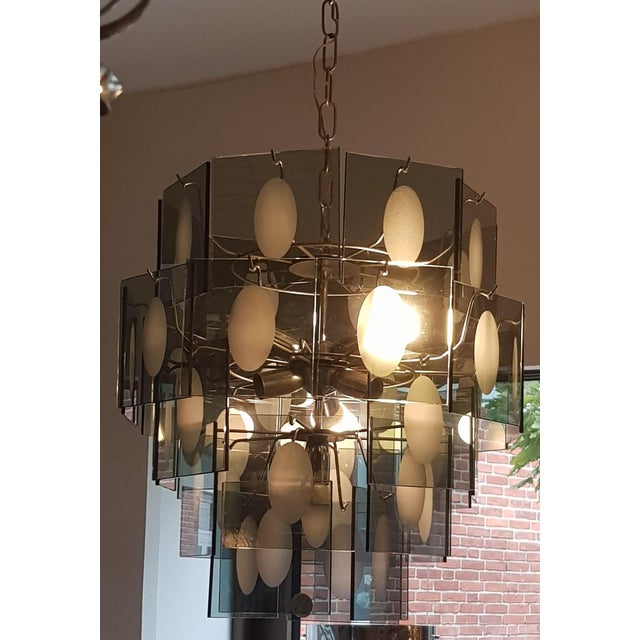 Plate chandelier from the 60's and 70's Compound of patterned glass platelets sandblasted, in relief, suspended on a...
