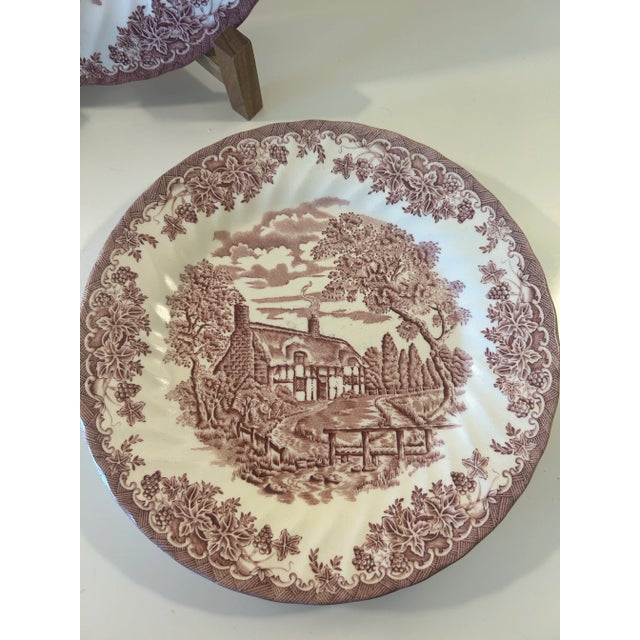 This lovely set of ironstone dinner pates are from Churchill England. The base is a milky white decorated with a country...