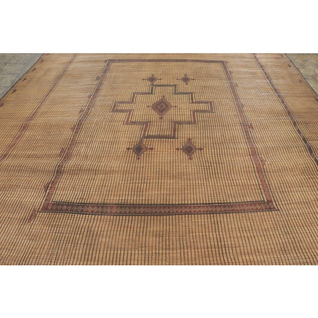 This vintage Moroccan mat is a primitive 12x16 Tuareg work from the nomadic tribe of the same name. Handwoven with reeds...