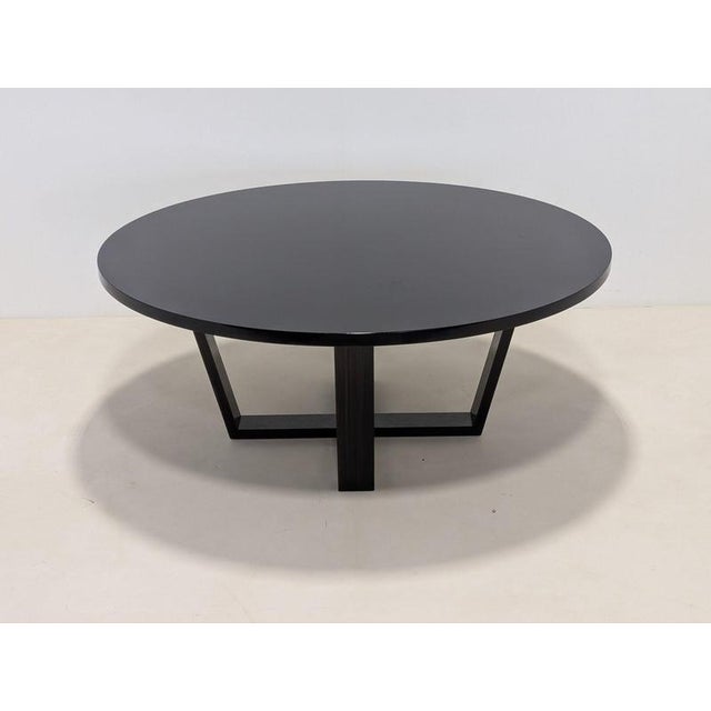 This custom-built round dining table features a striking architectural cross-brace base similar to Antonio Citterio’s...