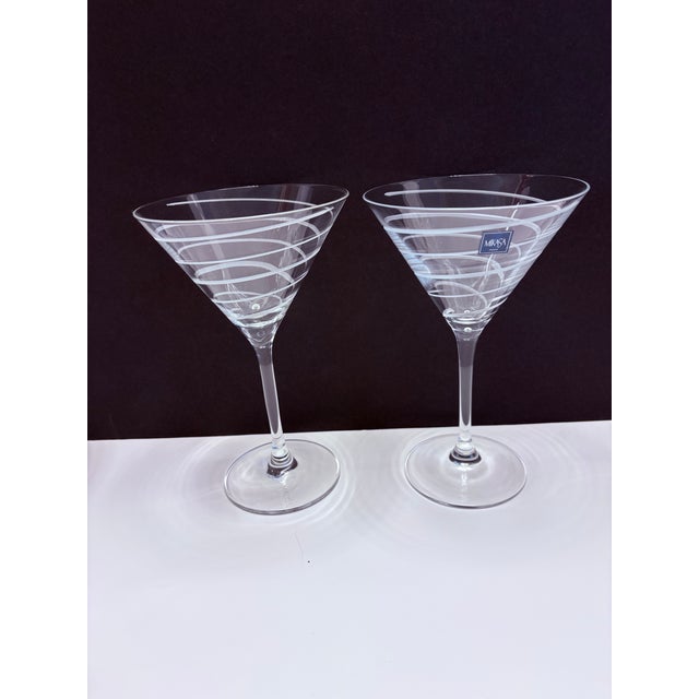 A refined pair of Mikasa martini glasses featuring an elegant etched spiral motif that wraps the bowl in a soft,...