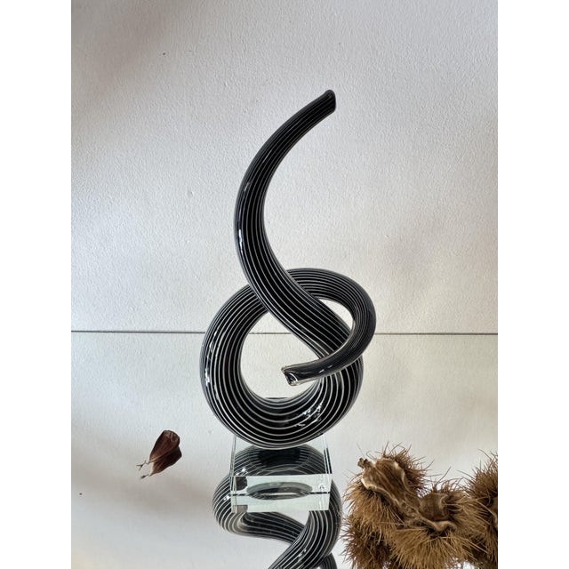 A striking sculptural glass object inspired by the iconic murano “love knot” forms associated with italian glass artist...