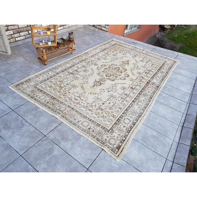 This is a vintage Turkish Oushak rug from the 1960s. The piece was hand-knotted.