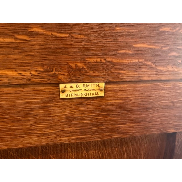 19th Century Oak Church Pew made by J & B Smith Cabinet Makers in Birmingham England. Carved Oak featuring a paneled back...