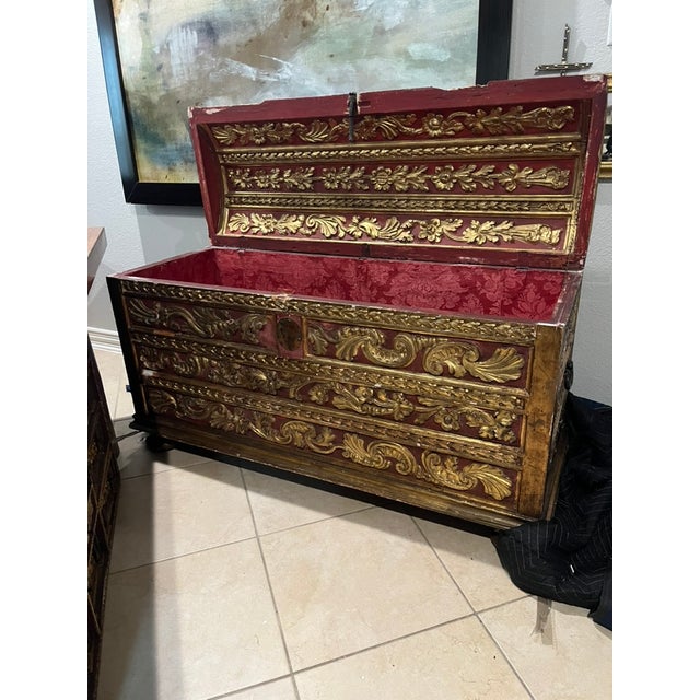 Profusely decorated with foliate sprays, conjoined scroll and gouge carved banding with bell flowers, the cover with metal...