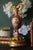 An elegant antique Sèvres-style porcelain ewer featuring a vivid pink ground with elaborate gilt decoration and an oval...