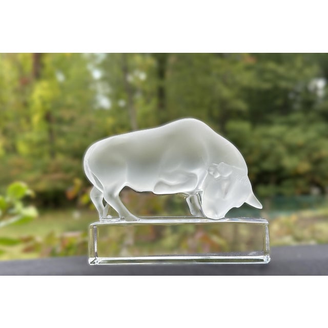 This striking Lalique crystal charging bull paperweight is crafted in frosted glass, showcasing the strength and elegance...
