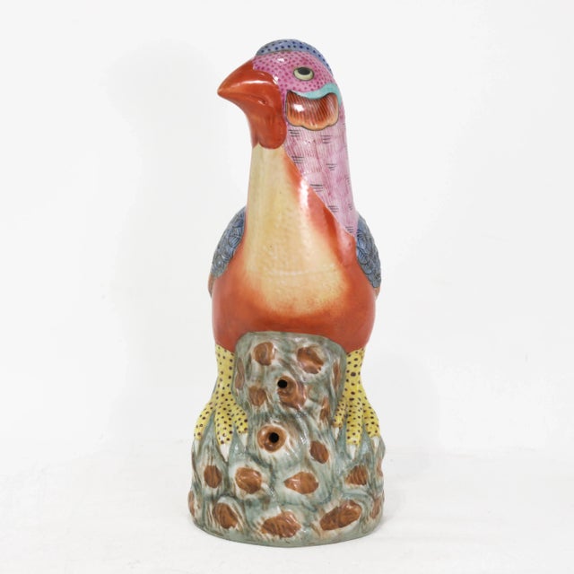A striking vintage Chinese porcelain bird figure, hand-painted in vivid enamels with finely detailed plumage in shades of...