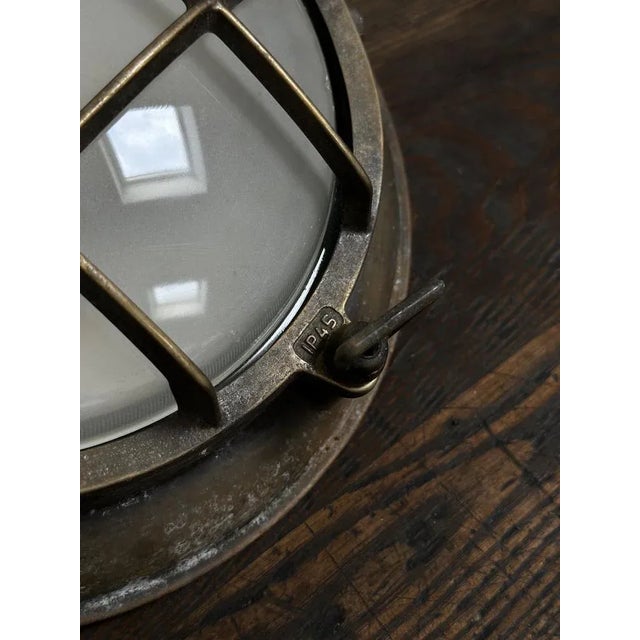 - a pair of brass circular ex-military wall lights with obscure convex glass shades, english circa 1930. - wonderful...