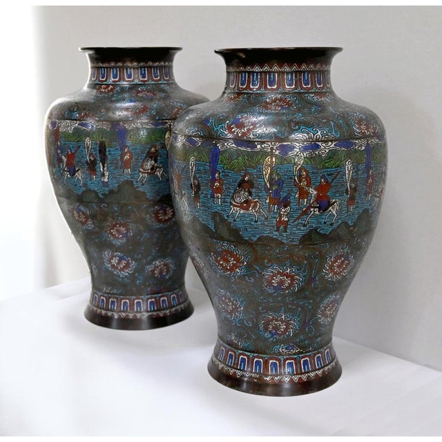 Designed in cloisonné enamel, these vases have a polychrome decoration representing the Japanese army made up of riders...