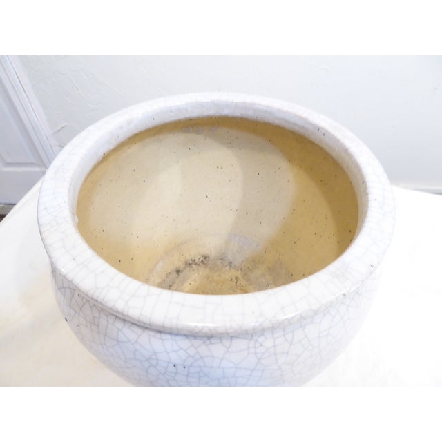 This crackle glaze planter has a drainage hole.