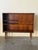 Danish cabinet crafted in richly grained rosewood, featuring clean Mid-Century Modern lines and elegant tapered legs. This...