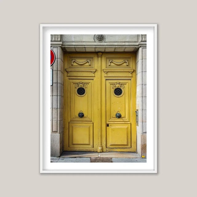 Historic European architecture often reveals its character at street level through tall, double doors - sometimes ornate,...