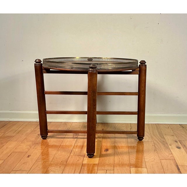 Vintage Mid Century Georgian-style wood and brass tray table. Features walnut wood folding base, removable wooden tray...